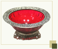 Bright red glass bowl with silver antique work on top & bottom